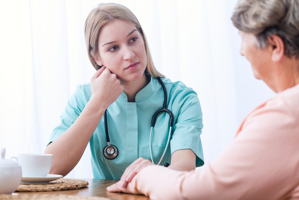 Female doctor during medical consultation at home